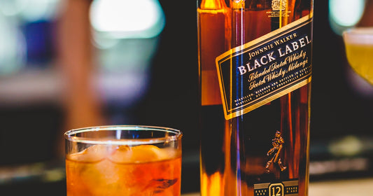 Bourbon glass next to pecans and gift items